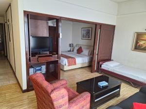 a hotel room with a bedroom with a bed and a tv at Best Apartment Suite At Times Square KL in Kuala Lumpur