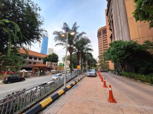 a street with orange cones on the side of a road at Best Apartment Suite At Times Square KL in Kuala Lumpur