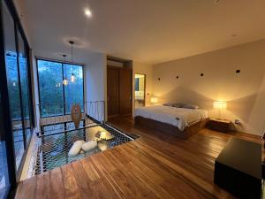 a bedroom with a bed and a large window at Atipika Tulum Apartments in Tulum +74 photos