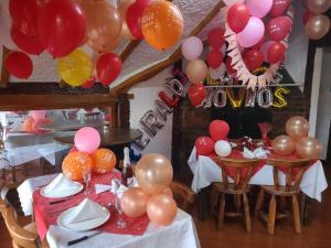 a room with two tables with balloons on them at The Frailejon House in Bogotá