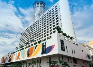 a large white building with colorful signs on it at JEN Penang Georgetown by Shangri-La in George Town