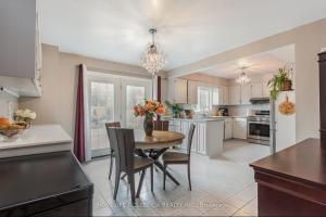 a kitchen with a table and chairs and a dining room at Tom oker in Mississauga