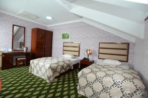 a hotel room with two beds and a bathroom at City Line Boutique Hotel in Tashkent