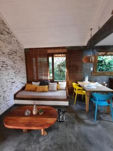 a living room with a couch and a table at Studio ideal para casais, ecológico na natureza in Marau