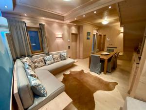 a living room with a couch and a table at Villa Zubiana in Cortina dʼAmpezzo