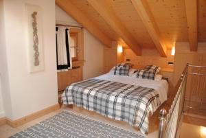 a bedroom with a bed in a wooden house at Villa Zubiana in Cortina dʼAmpezzo