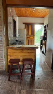 a kitchen with a wooden counter top in a room at Morada da colina casa de campo in Santo Antônio do Pinhal +64 photos