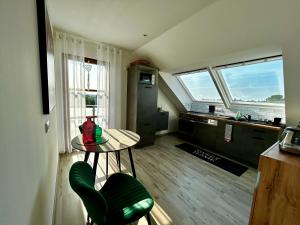 a kitchen with a table and a green chair in a room at Ferienwohnung Molschleben in Molschleben
