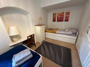 a small bedroom with a bed and a desk at Eagle Cottage in Penrith