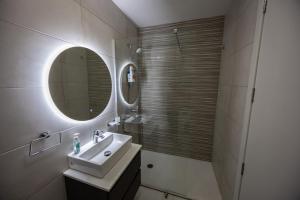 a bathroom with a sink and a mirror at 2-bed apartment in Mellieha with sea and country view in Mellieħa +18 photos