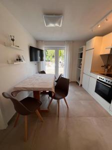 a kitchen with a table and chairs in a room at Tor ins Allgäu in Füramoos