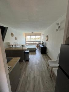 a large living room with a bed and a desk at Studio cabine vue mer Agde Ile des pecheurs in Cap d'Agde +23 photos