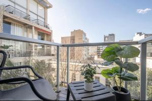 a balcony with a chair and a table and plants at Modern Studio in Palermo Hollywood in Buenos Aires