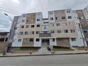 a large building on a street next to a road at Apartamento Portal 18 in San Alonso