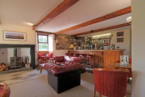 a living room with a fireplace and a bar at Embleton Spa Hotel & Apartments in Embleton