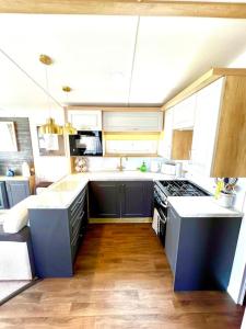 a kitchen with a sink and a stove top oven at The Lobster Pot in Tywardreath +31 photos
