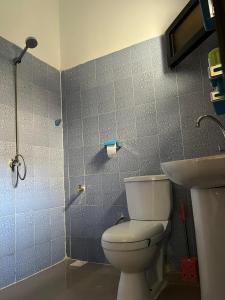 a bathroom with a toilet and a sink at Jamm in Saint-Louis +27 photos