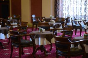 a room filled with tables and chairs with tablesearcher at City Line Boutique Hotel in Tashkent