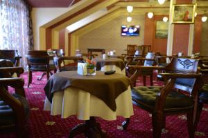 a restaurant with tables and chairs in a room at City Line Boutique Hotel in Tashkent