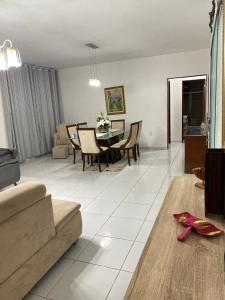 a living room and dining room with a table and chairs at Casa da Barra99 in Francês