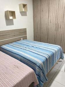 a bedroom with a bed with a blue blanket at Casa da Barra99 in Francês +33 photos