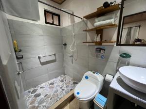 a small bathroom with a toilet and a sink at Apartamentos Mansión Tropical in Quepos +39 photos