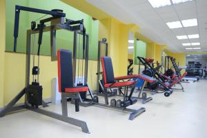 a gym with a row of tread machines in a room at City Line Boutique Hotel in Tashkent