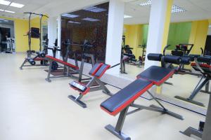 a gym with several treadmills and machines at City Line Boutique Hotel in Tashkent