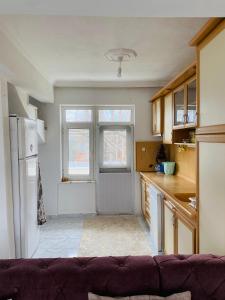 a kitchen with a couch in front of a window at Troya Garden Villa in Canakkale