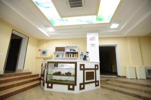 a display in a room with stairs and a skylight at City Line Boutique Hotel in Tashkent