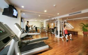 a gym with two people exercising on machines in a room at Liuhua Hotel in Guangzhou +28 photos