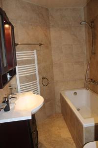 a bathroom with a sink and a tub and a toilet and a bath tub at Villa Katalina in Varna City