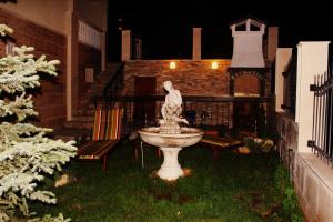 a fountain in the yard of a house at night at Villa Katalina in Varna City