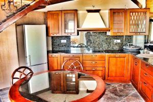 a kitchen with a table and a refrigerator at Villa Katalina in Varna City