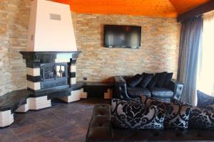 a living room with a couch and a fireplace at Villa Katalina in Varna City