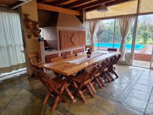 a dining room with a large wooden table and chairs at Nuestra Casa in San Pedro