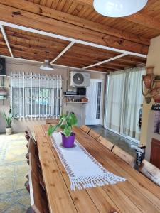 a room with a wooden table with a plant on it at Nuestra Casa in San Pedro