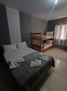 a bedroom with a bed with two towels on it at Casa na Praia de Canoas in Pontal do Paraná