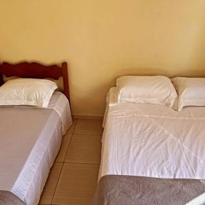 Ένα ή περισσότερα κρεβάτια σε δωμάτιο στο Refugio da Camboa - Casa Laranja