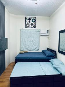 a bedroom with a blue bed in a room at 3BR Davao Condo 7thfloor near Airport in Pagamikan