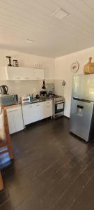 a kitchen with a stainless steel refrigerator in a room at La cabaña 2 dormitorios in Ocean Park