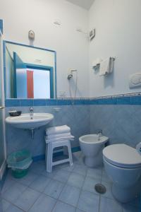 a bathroom with a sink and a toilet and a mirror at Oasi in Maiori