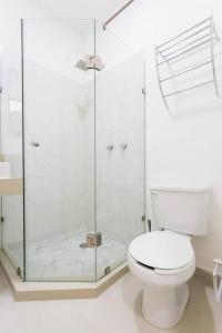 a bathroom with a toilet and a glass shower at M&Z Loft Las Palmas in Cancún +18 photos
