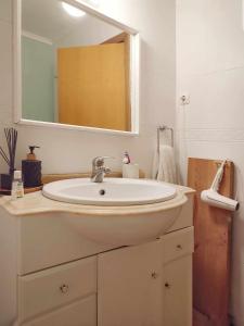 a bathroom with a sink and a mirror at Queen Bedroom in Aljezur