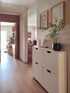 a living room with a white dresser with a plant on it at Queen Bedroom in Aljezur
