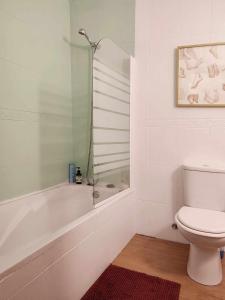 a bathroom with a shower and a toilet at Queen Bedroom in Aljezur