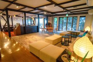 a living room with couches and a table and chairs at Marine Blue Yakushima in Yakushima +37 photos