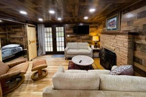 a living room with a couch and a fireplace at Great Little Cabin! in Ruidoso