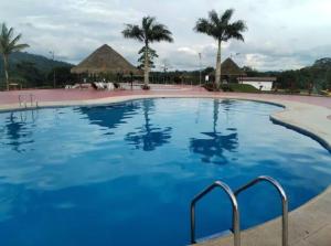 a large pool with blue water in a resort at Casa Campestre Wasi loma in Pedro Vicente Maldonado +19 photos