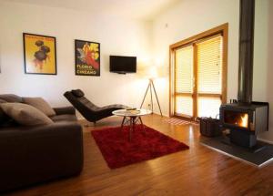 un soggiorno con divano e camino di Gullyview Spa Cottage Daylesford- Walk to town a Daylesford